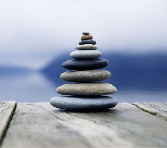 zen-balancing-pebbles-misty-lake